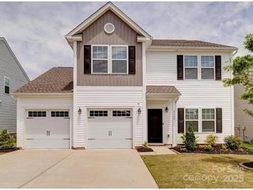 Charming two-story home with a two-car garage, nicely landscaped yard, and lovely curb appeal at 5121 Arbordale Way, Mount Holly, NC 28120
