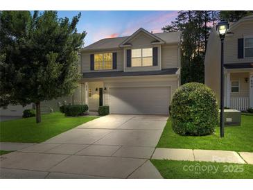 Charming two-story home with a well-manicured lawn and a two-car garage at 858 Rook Rd, Charlotte, NC 28216