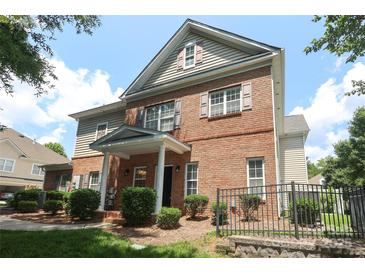 Charming two-story brick home with a well-manicured lawn and inviting entrance in a peaceful neighborhood at 12321 Aquitaine St, Charlotte, NC 28277