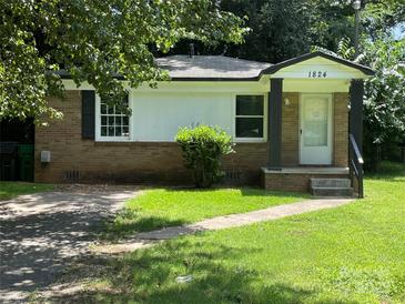 Charming single-story home with a brick facade, well-maintained lawn, and inviting front entrance at 1824 Maribel Ave, Charlotte, NC 28216
