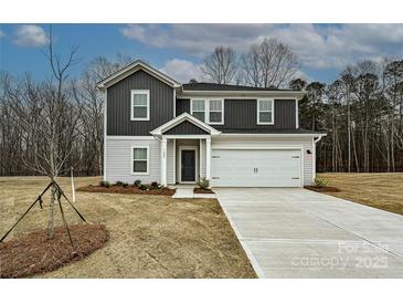 Charming two-story home with a gray and white facade, a two-car garage, and a well-manicured front yard at 2142 Sunflower Cir, Newton, NC 28658
