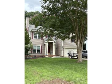 Charming two-story home with light brown siding, red shutters, well-manicured lawn, and attached two-car garage at 8618 Sam Dee Rd, Charlotte, NC 28215
