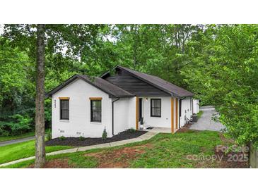 Charming home with fresh exterior paint, black trim, and a well-maintained front yard at 922 Maurice St, Monroe, NC 28112