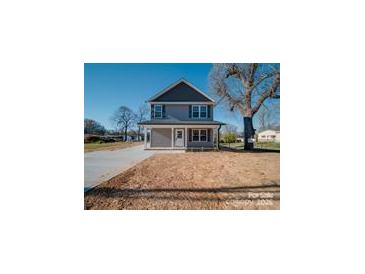 Charming two-story home with gray siding and a well-manicured front yard at 1017 W C St, Kannapolis, NC 28081