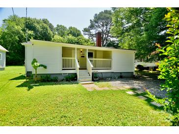 Charming one-story home with a cozy front porch and well-maintained lawn at 1020 N Ransom St, Gastonia, NC 28052