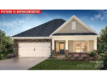 Charming single story home with stone accents, attached garage, well-maintained lawn, and inviting front porch at 1357 Secrest Commons Dr, Monroe, NC 28112