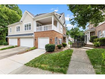 Charming townhome features a brick facade, covered porch, and attached garages at 15209 Loire Valley St, Charlotte, NC 28277