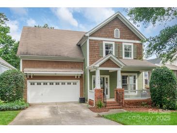 Charming two-story home features a welcoming front porch and a two-car attached garage at 2619 Merion Hills Ct, Charlotte, NC 28269