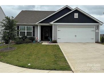 Charming single-Gathering home featuring a two-car garage, well-manicured lawn, and inviting curb appeal at 410 Apex Cir, Shelby, NC 28152