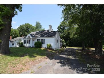 Charming single-story home with mature trees and a spacious front yard at 506 Linwood Rd, Gastonia, NC 28052