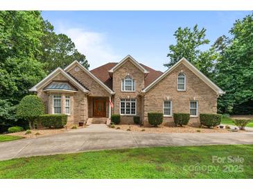 Charming brick home featuring manicured landscaping and a welcoming entrance at 8918 Beach Bluff Ct, Sherrills Ford, NC 28673