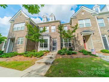 Charming brick townhome featuring well-maintained landscaping and inviting curb appeal at 11546 Red Rust Ln, Charlotte, NC 28277