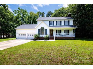 Charming two-story home featuring a two-car garage and a welcoming front porch at 1636 Springwinds Dr, Rock Hill, SC 29730