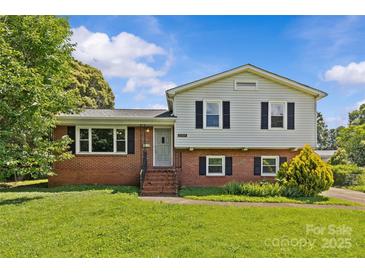 Charming two-story home with a brick facade, manicured lawn, and traditional architectural details at 2000 Townsend Ave, Charlotte, NC 28205