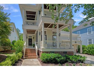 Charming home featuring a double porch, brick accents, and meticulous landscaping, enhancing its curb appeal at 202 Caldwell Ln, Davidson, NC 28036