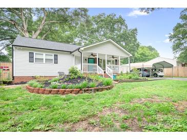 Charming single-story home with a welcoming front porch and landscaped garden at 2279 Cedar Oak Cir, Gastonia, NC 28052