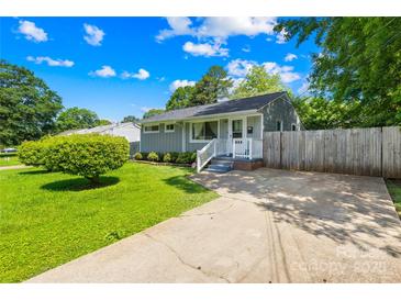 Charming single-story home with lush green lawn and a cozy front porch, perfect for relaxing and enjoying the outdoors at 411 Belvedere Cir, Kings Mountain, NC 28086