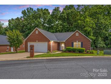 Charming one-story brick home featuring an attached garage and a well-manicured front yard at 103 Prestwick Ct, Salisbury, NC 28146