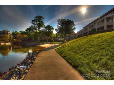 Beautiful waterfront community featuring manicured green space and private beach access with views of the lake at 14529 Waterside Dr, Charlotte, NC 28278