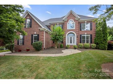 Charming brick two-story home with manicured lawn and arched doorway, perfect for curb appeal at 184 Melbourne Dr, Fort Mill, SC 29708