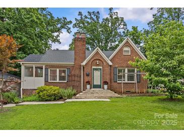 Charming brick home with well-maintained lawn, classic architectural details, and inviting entrance at 2005 Scott Ave, Charlotte, NC 28203