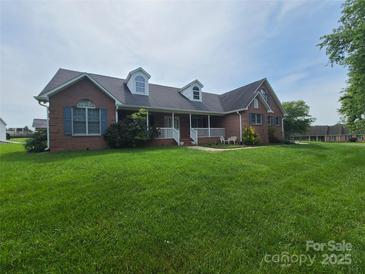 Charming single-Gathering home with a well-manicured front lawn, dormer windows, and a cozy front porch at 110 Kimberly Ln, Kings Mountain, NC 28086
