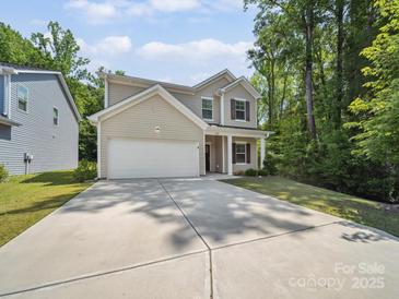 Inviting two-story home with a spacious driveway and well-maintained lawn at 125 Fosters Glen Pl, Mooresville, NC 28115