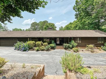Ranch-style home featuring a charming facade, mature landscaping, and a spacious driveway at 2915 Old Stage Rd, Gastonia, NC 28052