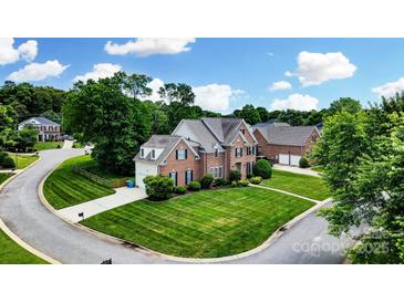 Beautiful red brick home with manicured lawn and mature trees in a desirable neighborhood at 4312 Beech Wood Ct # 140, Belmont, NC 28012