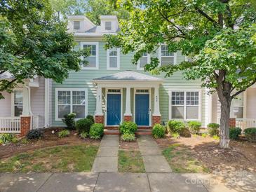Charming townhome featuring dual front doors and manicured landscaping at 435 Hurston Cir, Charlotte, NC 28208
