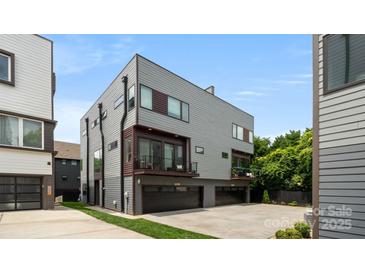 Modern gray home featuring a two-car garage, balcony, and clean architectural lines at 1011 Westbrook Dr # A, Charlotte, NC 28202