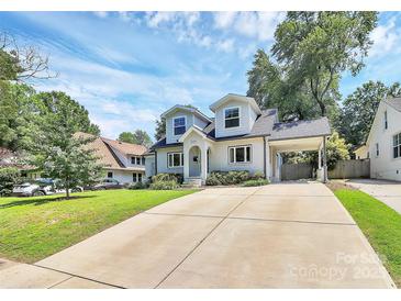 Charming two-story home featuring a well-manicured lawn, attached carport, and classic architectural details at 2333 Greenland Ave, Charlotte, NC 28208