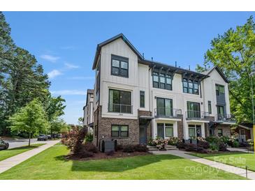 Charming townhome featuring modern design, beautiful landscaping, and a well-maintained lawn at 2969 Simpson Dr, Charlotte, NC 28205