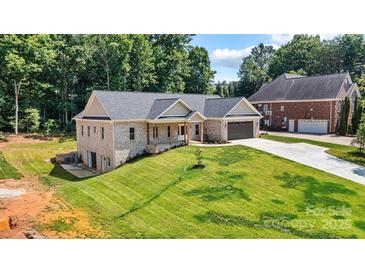 Stunning brick home with a well-manicured lawn and attached garage, perfect for families seeking comfort at 6249 Hayden Dr, Hickory, NC 28601