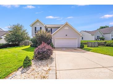 Charming two-story home features manicured lawn, neutral siding, and a convenient two-car garage at 6922 Brandon Chase Ln, Concord, NC 28025