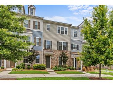 Charming multi-colored townhome with a stone facade and well-manicured lawn and mature landscaping at 9620 Ainslie Downs St, Charlotte, NC 28273