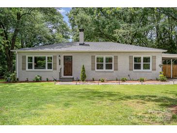 Charming brick ranch home with manicured lawn and mature trees at 1006 Home Trl, Gastonia, NC 28052