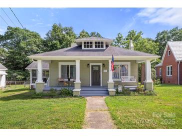 Charming bungalow home featuring a welcoming front porch and well-maintained lawn at 124 Marion St, Clover, SC 29710