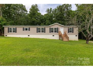 Inviting single Gathering home featuring a manicured lawn with a wooden porch and black shuttered windows at 159 Blackmon Pond Rd, Lancaster, SC 29720