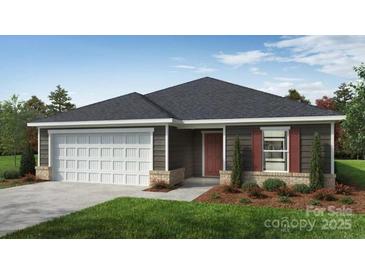 Charming single-story home with a two-car garage, neat landscaping, and a welcoming entrance at 2025 Cunningham Farm Dr, Indian Trail, NC 28079