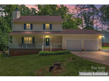 Charming two-story home with a cozy front porch and a well-maintained lawn at 308 Home Rd, Salisbury, NC 28147