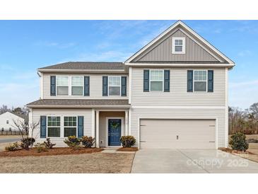 Two-story home with blue shutters, a blue door, and a two-car garage at 4060 Beacon Ave # 148, Monroe, NC 28110