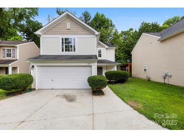 Charming two-story home with a white exterior, attached garage, and well-manicured landscaping at 6340 Green Vista Ct, Charlotte, NC 28212