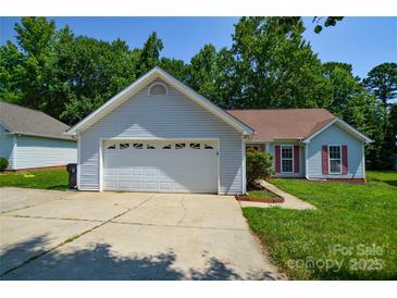 Charming single-story home featuring an attached garage, manicured lawn, and inviting curb appeal at 676 Rebecca Jane Dr, Mooresville, NC 28115