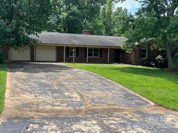 Charming one-story brick home with a long driveway and mature trees at 715 Sunridge Dr, Lincolnton, NC 28092