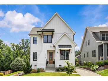 Charming two-story home featuring crisp white siding, black window trim, and a welcoming front porch at 113 Prince St, Belmont, NC 28012