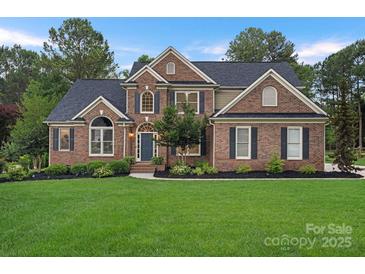 Charming brick two-story home features a well-manicured lawn and inviting front entrance at 116 Ivy Hollow Ln, Mooresville, NC 28117