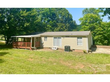 Charming single-story home featuring a covered porch and a well-maintained lawn surrounded by lush trees at 121 C & K Dr # 60, Taylorsville, NC 28681