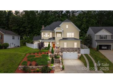 Charming two-story home with manicured landscaping and a two-car garage at 2117 Middlebridge Ct, Fort Mill, SC 29715