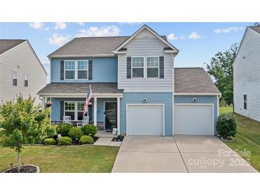 Charming two-story home with a well-manicured lawn and a two-car garage at 214 Hidden Lakes Rd, Statesville, NC 28677